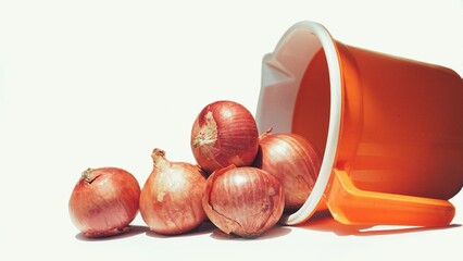 Onions pored out from a mug