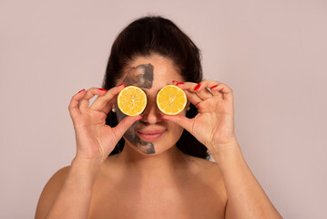 Caucasian woman portrait in 30 -40 ages with clay face mask with lemon vitamin C