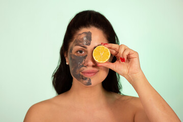 Caucasian woman portrait in 30 -40 ages with clay face mask with lemon vitamin C