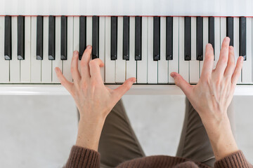 Closeup top view photo of grand piano with musican hands playing music