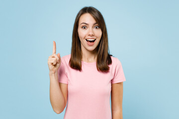 Young excited fun happy proactive woman 20s wearing pink t-shirt holding index finger up with great...