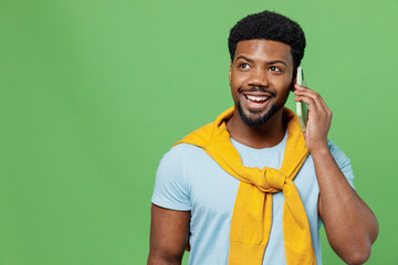Young fun man of African American ethnicity 20s wear blue t-shirt talk speak on mobile cell phone...