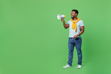 Full body young man of African American ethnicity 20s wear blue t-shirt hold scream in megaphone...