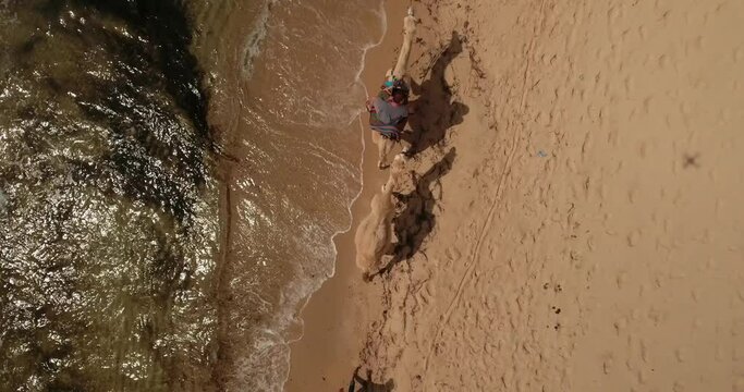 Aerial Top Upward Shot Of Male Tourist Enjoying Camel Ride By Coastline At Beach On Vacation - Djerba, Tunisia