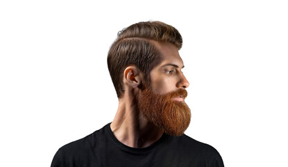 Young bearded man standing against black background. Side view portrait of thinking stylish young...