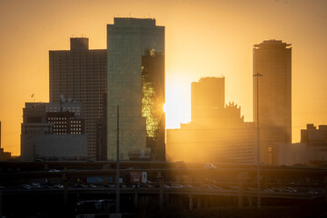 Fort Worth, TX USA - March 19, 2022: Sun setting behind towers in Downtown Fort Worth