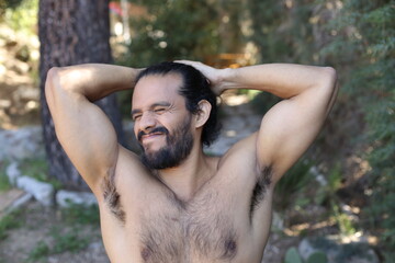 Man smelling armpits with embarrassment