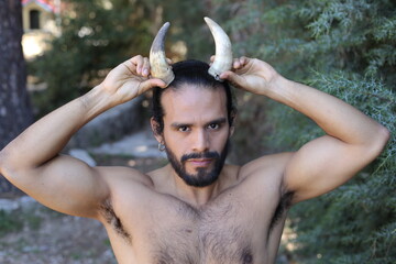 Shirtless muscular man with pair of horns - obrazy, fototapety, plakaty
