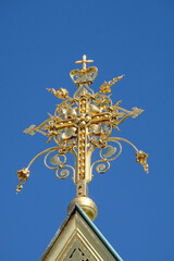 Golden cross against blue sky on russian chapel at Mathildenhoehe, Darmstadt