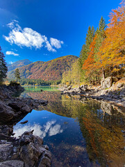 Fototapeta na wymiar Laghi di Fusine - Friuli Venezia Giulia (Italy). Autumn in the mountains, foliage on the lake. Autum reflections on the lake.