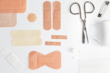 different styles of band aids scissors and gauze