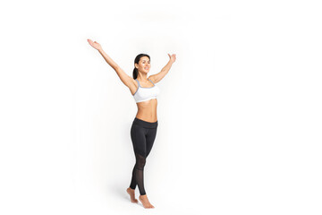 a girl in sportswear stands with her hands raised up, isolated on a white background