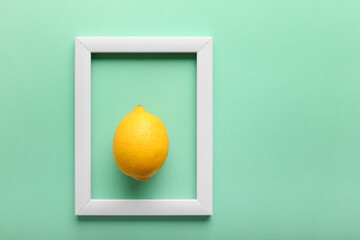 White frame and lemon on green background