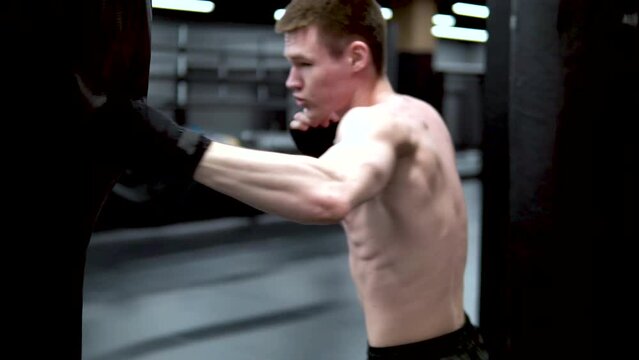 Black grsh in man gym A the beats in bandages boxer training man, concept healthy lifestyle studio glove in sport and punch black, ring kick. Athletic challenge gym,