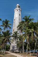 Fototapeta na wymiar Ocean lighthouse surrounded by palm trees