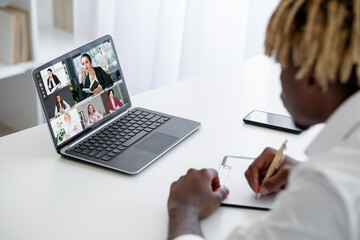 Business webinar. Video chat. Distance education. Guy watching online lesson with female coach speaking students taking notes on laptop screen in virtual class.