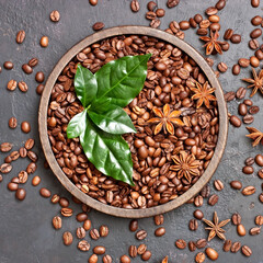 Roasted coffee beans with green leaves