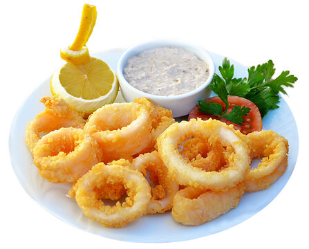 calamary on white dish with greens