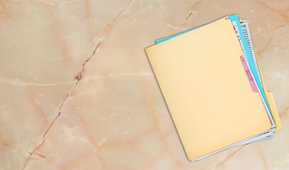 Paper file with documents on wooden table, top view. Space for text