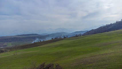 Fototapeta premium Pastures on the road to the mountains green alpine meadows