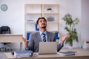 Young male employee working in the office