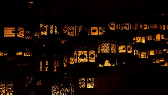 Flickering lanterns in the dark. Silhouettes ornamental brozne lantern in Kasuga Taisha Nara, Japan. High quality 4k footage