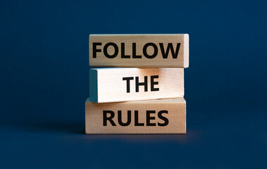 Follow the rules symbol. Concept words Follow the rules on wooden blocks. Beautiful grey background. Business and follow the rules concept. Copy space.