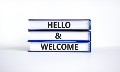 Hello and welcome symbol. Concept words Hello and welcome on books. Beautiful white table white...