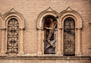 Old ruined church. Bent crosses and broken walls of the temple, ancient forged frames on the...