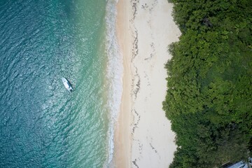 Aerial view of single kayak against backdrop of sea, sand and beach over Curieuse Island, Seychelles.