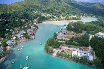 Drone field of view of turquoise blue water and harbour in Praslin, Seychelles.