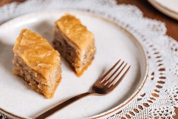 Turkish or Bosnian dessert called Baklava with on a wooden board. Popular dessert for Ramadan and Eid Mubarak