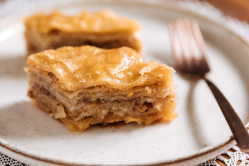 Turkish or Bosnian dessert called Baklava with on a wooden board. Popular dessert for Ramadan and Eid Mubarak