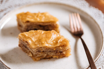 Turkish or Bosnian dessert called Baklava with on a wooden board. Popular dessert for Ramadan and Eid Mubarak