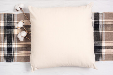 Pillow case Mock up. Flat lay mockup of beige square cushion with cotton flowers and scarf on a...