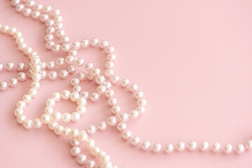 Pink pastel pearls bead on cute rose background with copy space. Soft focus
