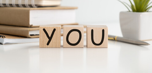 Love you letter on wood block cubes on wooden table over blur green tree in park