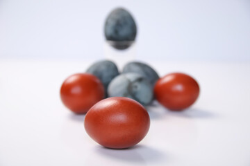Defocus blue and red eggs on white background. Minimal Easter celebration concept. Design, visual art, minimalism. Balance and harmony concept. Mental health. Pattern. Zen. Out of focus