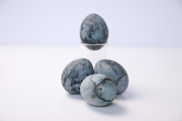 Defocus blue eggs. Close up Easter eggs pastel colored on white background. Minimal Easter celebration concept. Design, visual art, minimalism. Balance and harmony concept. Mental health.Out of focus