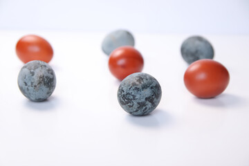 Defocus blue and red eggs on white background. Minimal Easter celebration concept. Design, visual art, minimalism. Balance and harmony concept. Mental health. Pattern. Out of focus