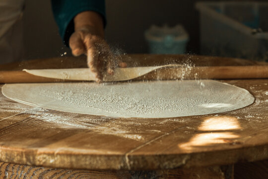 Woman's hand rolling dough for pancakes in Antalya, Turkey. SELECTİVE FOCUS