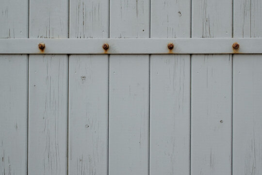 wooden door with rusty nails
