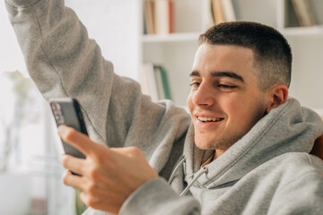 Fototapeta premium young man with mobile phone at home