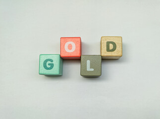 a series of letters in a children's toy puzzle block into the word gold