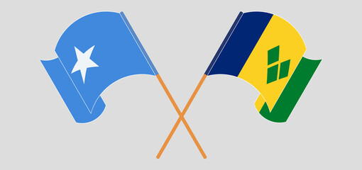 Crossed and waving flags of Somalia and Saint Vincent and the Grenadines