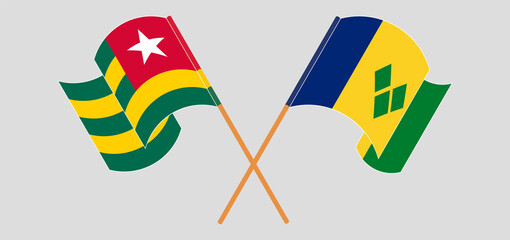 Crossed and waving flags of Togo and Saint Vincent and the Grenadines