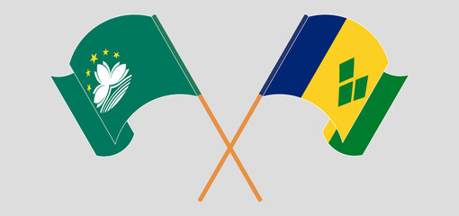 Crossed and waving flags of Macau and Saint Vincent and the Grenadines