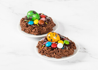 Festive dessert. Easter chocolate cookie in the shape of a nest, decorated with a quail egg and...