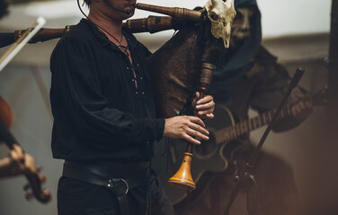 Fototapeta na wymiar Medieval musician playing the bagpipes