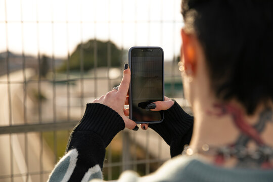 Girl taking photo through her smartphone